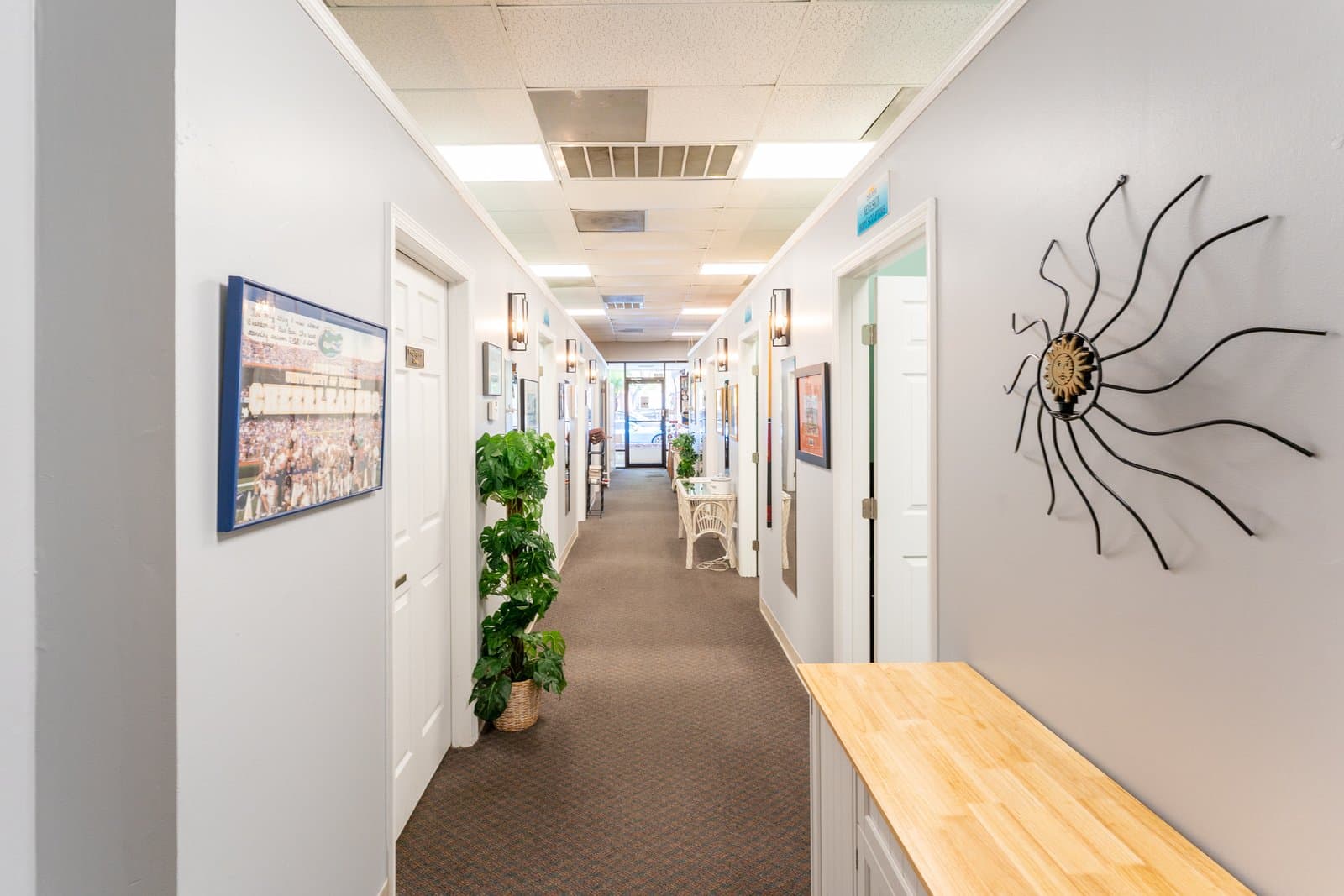 Clean hallway of private tanning and wellness rooms at Sun Bar in Brandon, FL